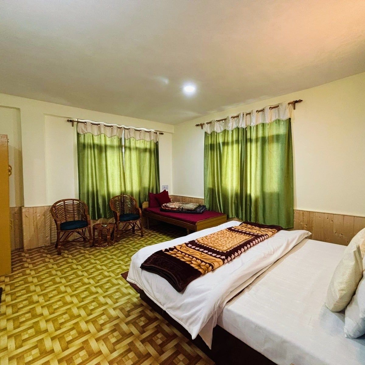Large room with a double bed, a day bed and two windows